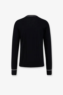Dolce &amp; Gabbana men’s black virgin wool sweater with long sleeves and white trim at neckline and cuffs
