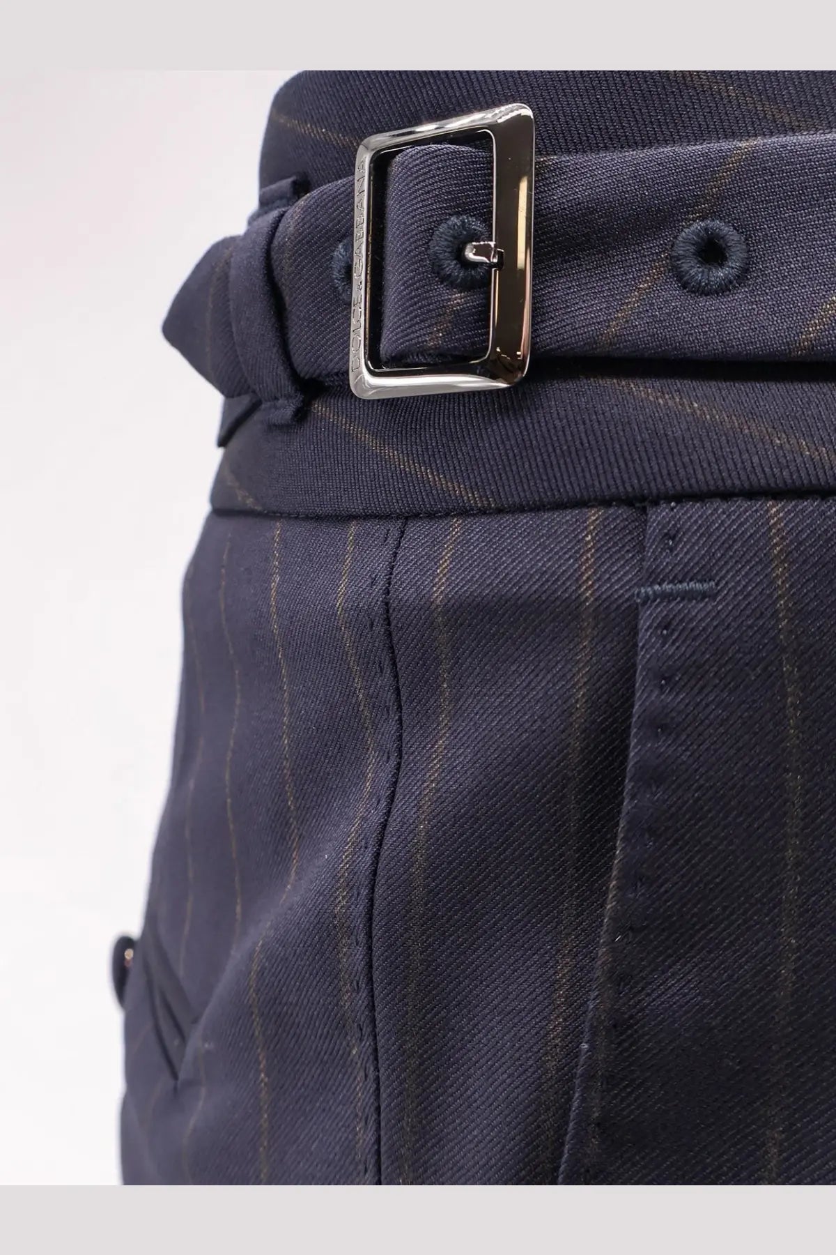 Dolce &amp; Gabbana men’s navy blue pinstripe virgin wool trousers with a silver-toned rectangular buckle front view