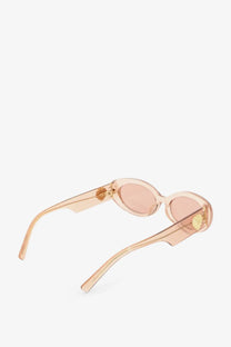 Dolce &amp; Gabbana women’s translucent peach acetate sunglasses with oval lenses and gold tone temple accents