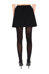 Black high-waisted flared double crepe skirt with central back zipper by dolce &amp; gabbana shown from back side