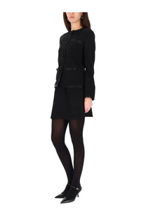 Black tailored blazer with structured shoulders and front button closure complementing dolce &amp; gabbana skirt