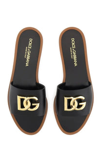 Dolce &amp; Gabbana women’s black leather slide sandals with gold-tone dg logo hardware and brown rubber soles