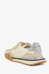 Cream-colored dolce &amp; gabbana women’s sneaker with suede and canvas upper gray heel tab and layered rubber sole