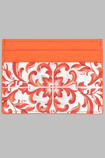 Dolce &amp; Gabbana women’s orange leather card holder with vibrant orange and white floral pattern and glossy finish