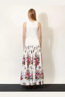 A woman wears a dolce &amp; gabbana women’s white ribbed cotton sleeveless top paired with a floral maxi skirt