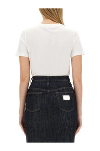 Dark blue denim skirt with silver rectangular patch on back pocket shown from the back complementing dolce &amp; gabbana women’s shirt white