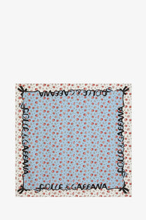 Dolce and Gabbana women’s light blue silk foulard with red floral pattern and black script branding along edges
