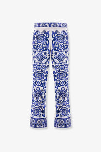 Dolce &amp; Gabbana women’s silk trousers in white with intricate blue ceramic tile pattern and symmetrical designs