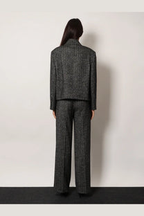 A tailored charcoal gray herringbone wool blend double breasted blazer by dolce and gabbana with structured collar and long sleeves