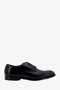 Doucal’s men’s black patent leather derby shoe with sleek polished finish and classic lace up design