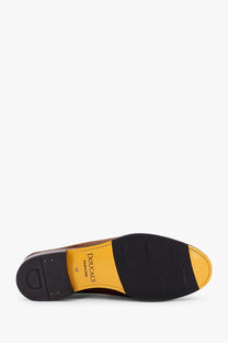 Black and yellow leather sole of doucal’s men’s suede loafers in gold shown from the back side