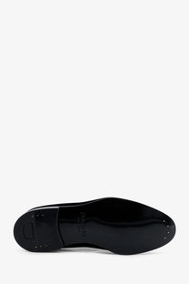 Black patent leather sole with glossy finish and dior logo embossed on the back of doucals men’s velvet loafers