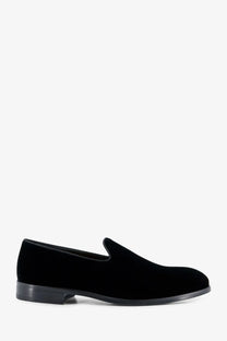 Doucal’s men’s black velvet slip-on loafer with sleek minimalist design and low-profile rubber sole