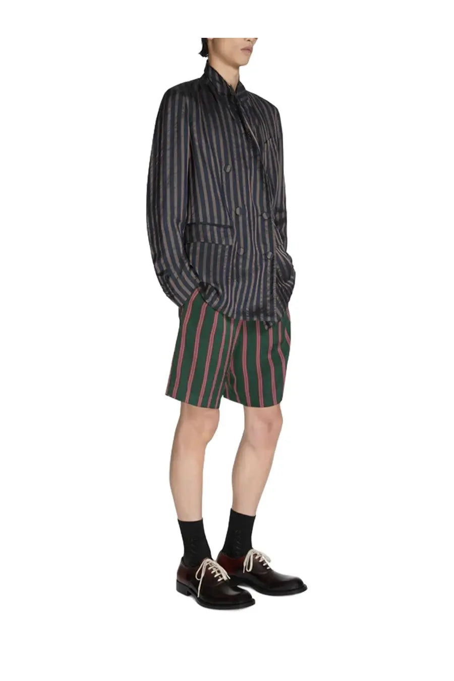 Dries Van Noten men’s blazer balto blue paired with a dark gray and black striped button-up shirt and matching shorts