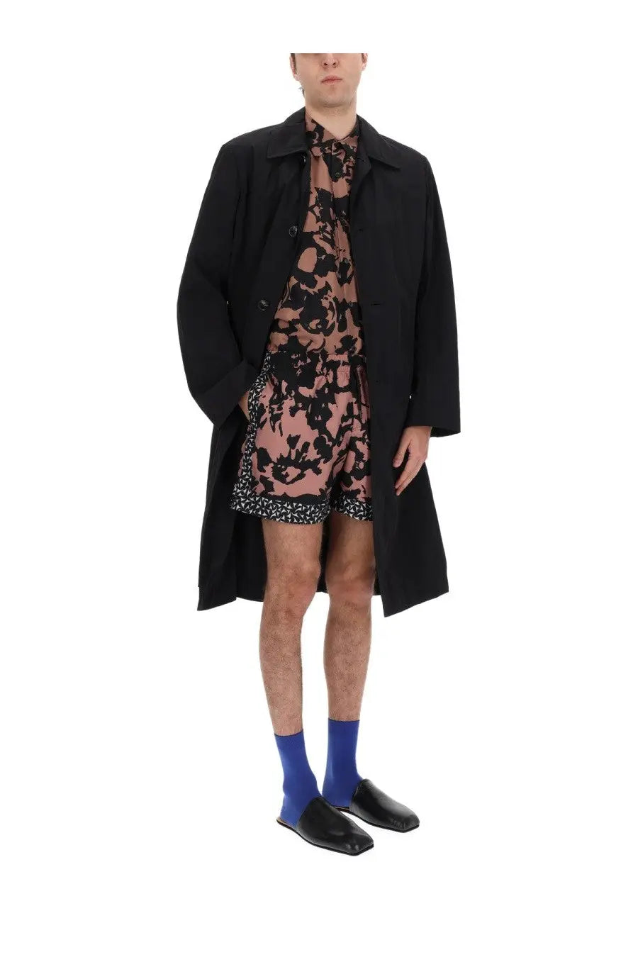 Dries Van Noten men’s rankles black trench coat with classic collar and button closure over pink floral dress