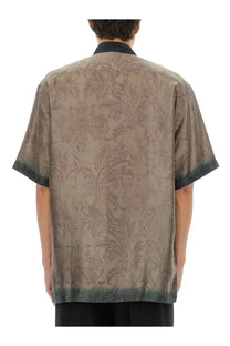 A taupe silk short-sleeved shirt with subtle damask pattern and dark green gradient trim by Dries Van Noten