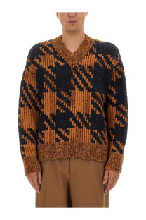 A cozy chunky-knit v-neck sweater in bold black and burnt orange plaid by Dries Van Noten men’s wool jersey multicolor