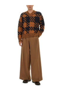 A cozy knitted wool jersey sweater by dries van noten in navy and mustard houndstooth with ribbed cuffs and hem
