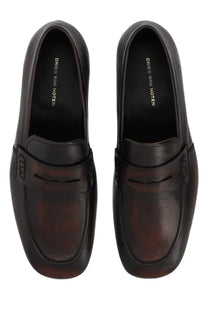 Black leather loafers with brown patina and stitched detailing featuring the dries van noten logo on the insole