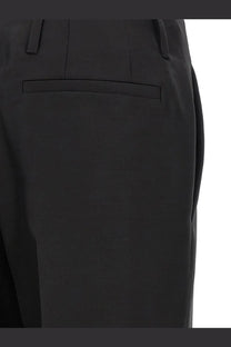 Black tailored Dries Van Noten women’s paloma wool and silk trousers with sleek design and subtle waistband pleats