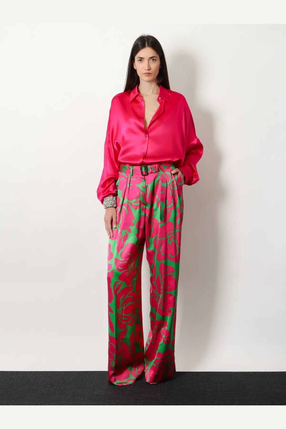 Vibrant fuchsia satin blouse with relaxed fit and button-down front paired with dries van noten green viscose trousers