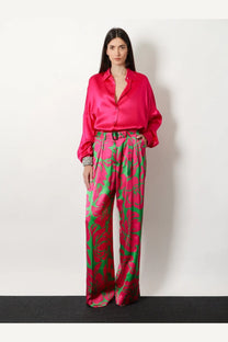 Vibrant fuchsia satin blouse with relaxed fit and button-down front paired with dries van noten green viscose trousers