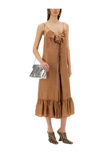 A silver metallic clutch with a textured crinkled surface and gold tone clasp paired with dries van noten beige dress