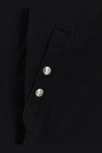 Drkshdw men’s black denim jacket featuring a black jacket flap pocket with two silver buttons