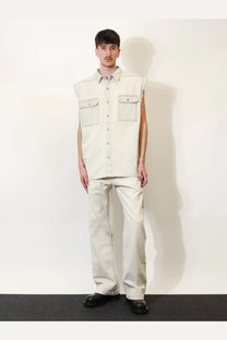 A light beige sleeveless denim vest with front flap pockets and button-down front from DRKSHDW men’s collection