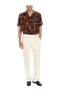 Drôle de monsieur men’s brown short-sleeved button-up shirt with colorful cane handle pattern on dark background
