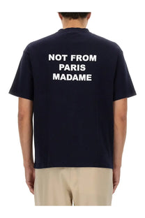 Back of navy blue cotton short-sleeved t-shirt with white not from paris madame text by drôle de monsieur