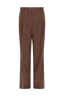 Brown pleated tailored fit trousers with subtle texture by drôle de monsieur men’s golfeur chevrons collection