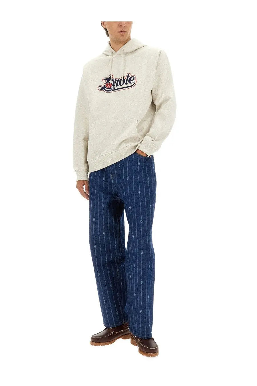 Cream-colored hoodie with drole logo in black and red script across the chest from drôle de monsieur men’s collection