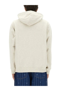 A cream-colored, soft-textured hoodie with relaxed fit and ribbed cuffs from drôle de monsieur men’s drôle rose sweatshirt gray collection