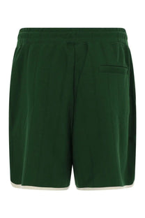 Drôle de Monsieur men’s hibiscus green athletic shorts with drawstring waistband and white trim along the hem