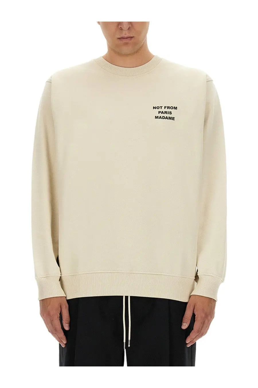 Drôle de Monsieur men’s cream crewneck sweatshirt with black slogan text not from Paris Madame on left chest