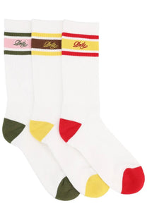 Three pairs of white crew socks with colorful striped bands and dolce logo embroidery by drôle de monsieur