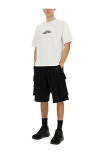 White short-sleeved t-shirt with black abstract logo paired with dsquared2 men’s black cargo bermuda shorts