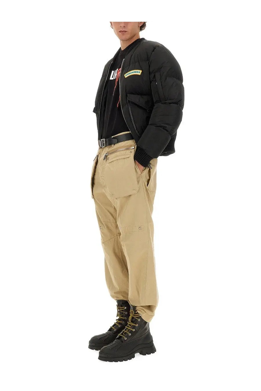 Dsquared2 men’s beige cargo pants paired with a black quilted puffer bomber jacket featuring a green chest patch