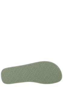 The sole of a dsquared2 men’s flip flop slipper in light olive green rubber with an embossed repeating pattern