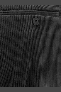 Black dunst men’s corduroy trousers with textured ribbed fabric and matching black four-hole button close-up