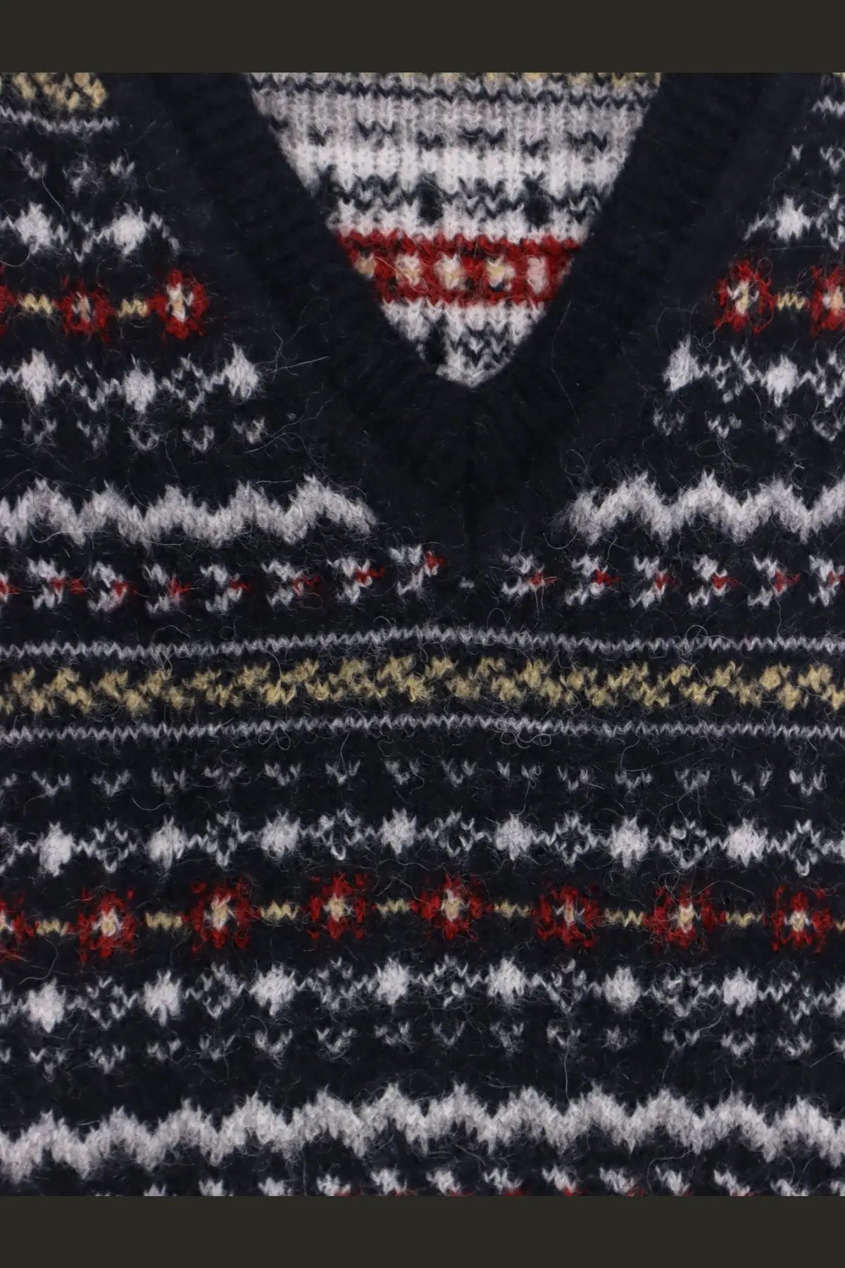 Dark navy knit v-neck sweater with intricate fair isle patterns in white red and beige by dunst unisex vest blue