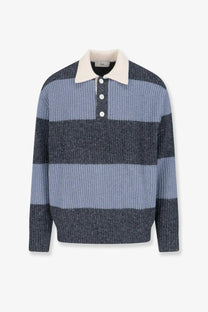 A men’s knitted DUNST unisex wool blend polo sweater in blue with horizontal stripes, cream collar, and white buttons