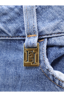Gold-tone rectangular metal clasp with embossed et logo on light blue denim fabric of elisabetta franchi urban cotton jeans