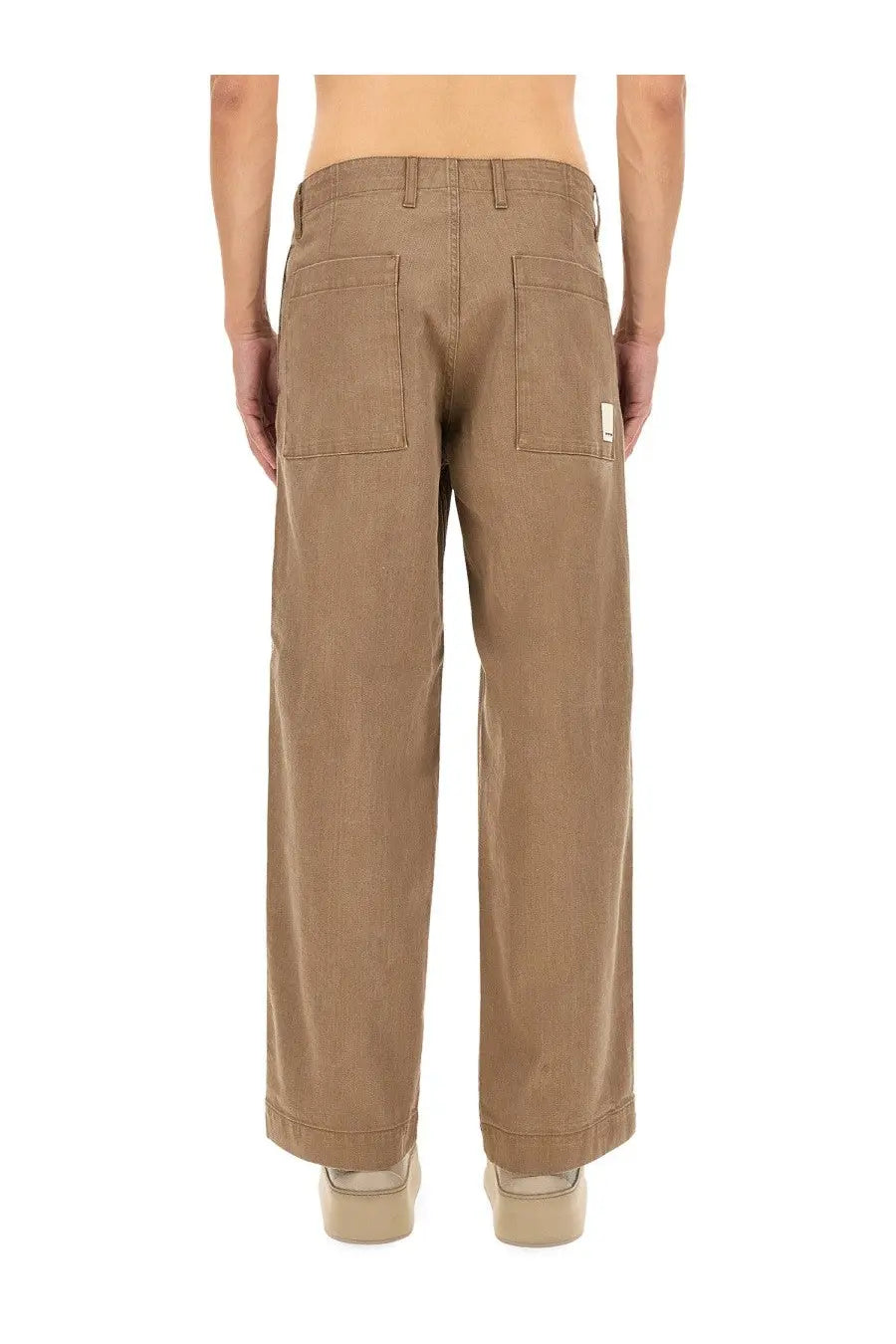 Back view of tan wide-leg chino pants with two back pockets and white label on right pocket from emporio armani