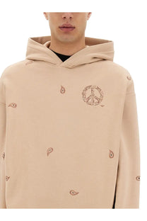 Emporio Armani men’s beige hoodie with embroidered peace sign and paisley motifs on soft cotton fabric