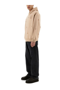 Emporio Armani men’s beige hoodie with subtle embroidered peace signs and small circular motifs across the front