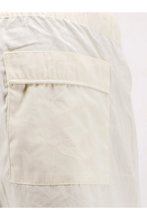 A cream-colored lightweight fabric pocket with neat stitching on entire studios unisex cotton bermuda shorts white