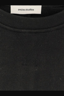Black entire studios unisex pod crew sweatshirt with ribbed cotton fabric and subtle x-shaped seam detail