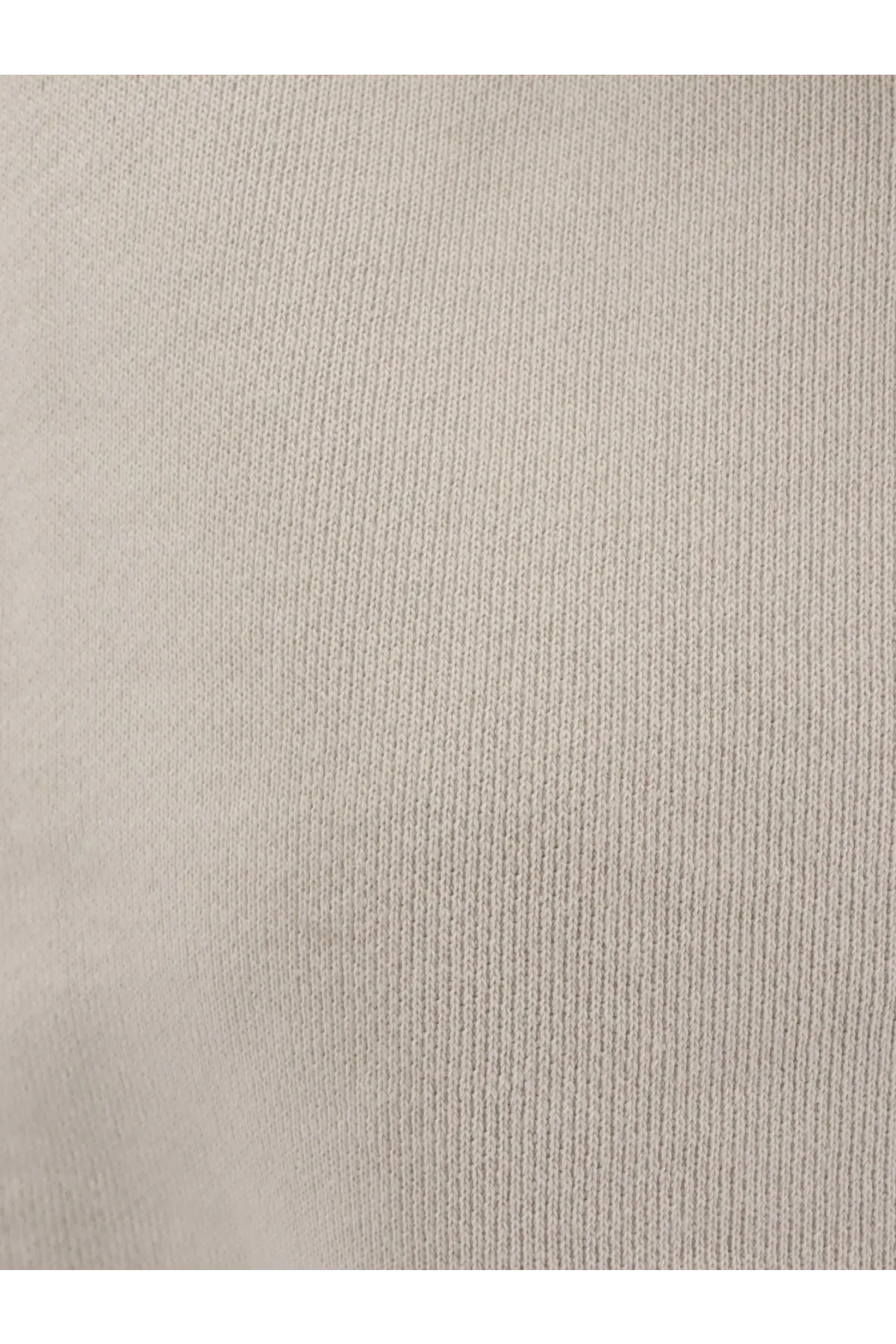Beige ribbed knit fabric of entire studios women’s white cotton jogging trousers showcasing soft textured surface